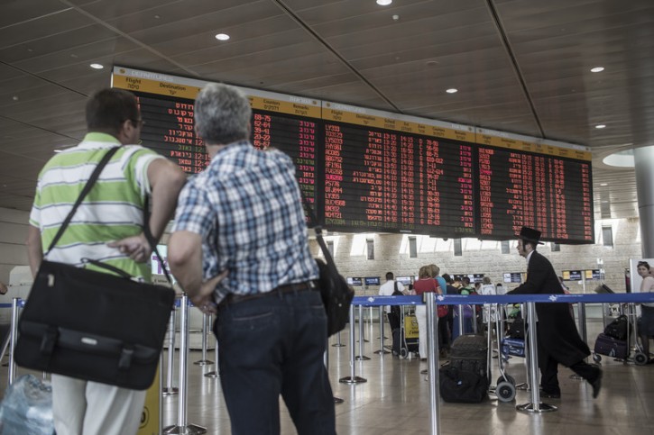 Travellers look a board announcing departures from the Ben Gurion airport, outside Tel Aviv, Israel, 18 September 2014. EPA/OLIVER WEIKEN