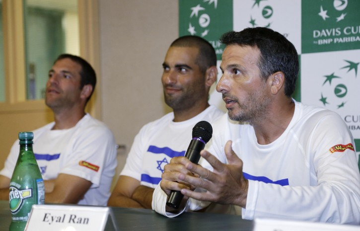 Israel team captain Eyal Ran, right, gestures as he speaks during a news conference as Jonathan Erlich, left, and Andy Ram, center, listen, Tuesday, Sept. 9, 2014, in Sunrise, Fla. Israel and Argentina will play a Davis Cup tennis tie in Sunrise later this week. (AP Photo/Wilfredo Lee)