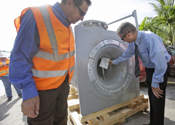 City of Miami Beach, Fla., assistant directors of Public Works, Mike Alvarez, left, and Jay Fink, look at new water pumps that will be part of a new storm water pump station being installed, Wednesday, Sept. 17, 2014 in Miami Beach. City officials say the annual king tides are expected to be almost three inches higher than last year. Extreme high tides in the fall and spring push seawater up through aging infrastructure, flooding some Miami Beach streets with more than a foot of water even on sunny days, snarling vehicle and pedestrian traffic. (AP Photo/Wilfredo Lee)