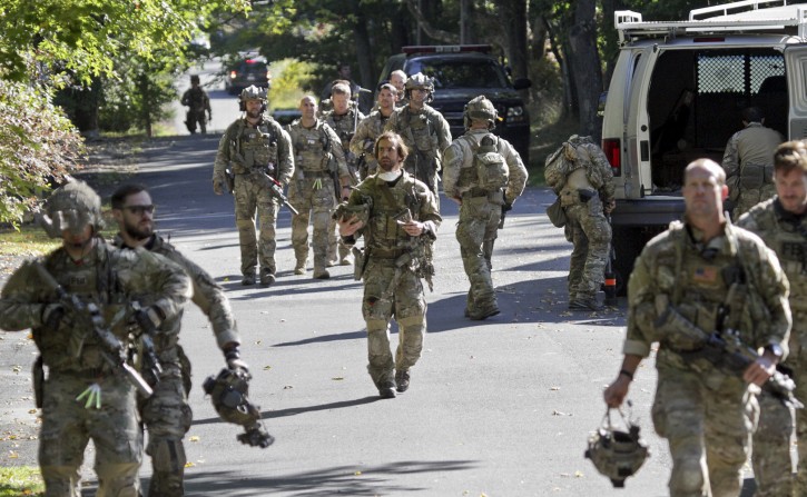 FBI along with various state police officers exit a wooded area at Buck Hill Falls in Barrett Township, Pa., where the search for Eric Frein continues Friday, Sept 26, 2014. Frein is suspected of fatally shooting a state trooper and wounding another at the Blooming Grove state police barracks two weeks ago. (AP Photo/Scranton Times & Tribune, Michael J. Mullen)