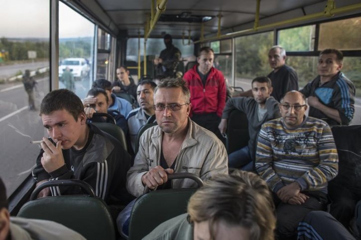 Members of the pro-Russian rebels, who are prisoners-of-war (POWs), sit inside a bus as they wait to be exchanged, north of Donetsk, eastern Ukraine, September 20, 2014. The two sides, that of the government forces and the pro-Russian separatists, are exchanging POWs under the terms of the current ceasefire. REUTERS/Marko Djurica