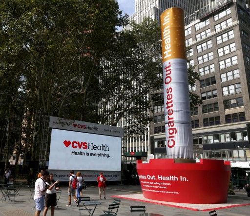 FILE - In this Sept. 3, 2014 file photo, an inflatable cigarette and ashtray are displayed in New York to announce the CVS Health's decision to stop selling cigarettes at its stores. CVS Health, the nation's second-largest drugstore chain, is developing a new tobacco-free pharmacy network for clients of its Caremark pharmacy benefits management business. (AP Photo/Seth Wenig, File)
