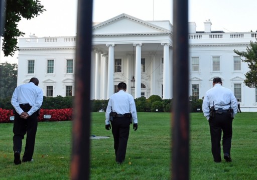 Uniformed Secret Service officers walk along the lawn on the North side of the White House in Washington on Saturday, Sept. 20, 2014. SUSAN WALSH/AP