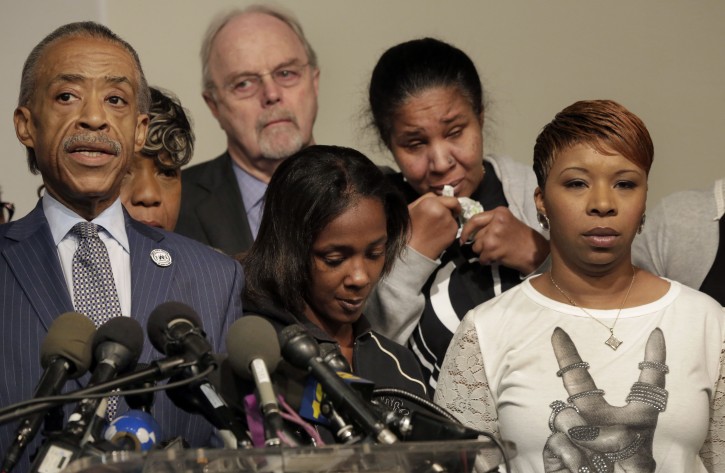 Rev. Al Sharpton, Kimberly Ballinger, domestic partner and mother of Akai Gurley's daughter and Lesley McSpadden, mother of Michael Brown, front row left to right, attend a news conference at National Action Network headquarters, in New York,  Wednesday, Nov. 26, 2014.  AP