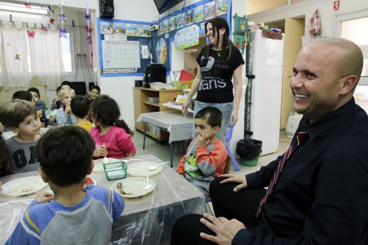 Itamar Shimoni, Israeli mayor of the costal city of Ashkelon, visits a kindergarten in Ashkelen, Israel, Thursday, Nov. 20, 2014.(AP Photo/Tsafrir Abayov)