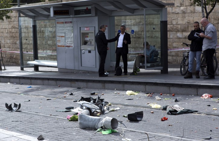 Vegetables are scattered among other debris on the tracks of a Light Rail trolley station as Israeli police question witnesses after a Palestinian man drove a van into a crowd of police and civilians at this station in East Jerusalem, 05 November 2014.  EPA