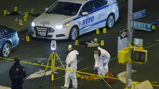 Investigators work at the scene where two NYPD officers were shot on Dec. 20 in the Bedford-Stuyvesant neighborhood of the Brooklyn borough of New York.  Photo credit: AP Photo/John Minchillo