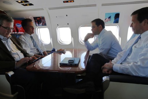 FILE - Republican presidential nominee Mitt Romney is joined by former Florida Governor Jeb Bush (L), U.S. Senator Marco Rubio (R-FL) (2nd R) and U.S. Representative Connie Mack (R-FL) (R) onboard his campaign plane enroute to Miami, Florida October 31, 2012.   REUTERS/Brian Snyder