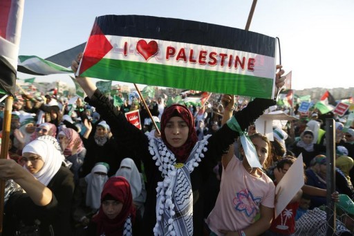 FILE - A supporter of the Jordanian Muslim Brotherhood holds up a Palestinian flag during a rally in Amman, Jordan, August 29, 2014. Reuters