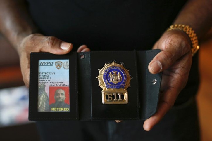 The badge and identification card of retired NYPD detective Harold Thomas are seen in West Hempstead, New York December 17, 2014. Reuters interviewed 25 African American male officers on the NYPD, 15 of whom are retired and 10 of whom are still serving. All but one said that, when off duty and out of uniform, they had been victims of racial profiling, which refers to using race or ethnicity as grounds for suspecting someone of having committed a crime. Picture taken December 17, 2014. REUTERS/Shannon Stapleton 