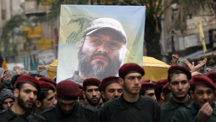 Lebanon's Hezbollah guerrillas carry a poster and the coffin of their assassinated commander Imad Moughniyah during his funeral in Beirut's suburbs February 14, 2008. Hezbollah's chief Sayyed Hassan Nasrallah on Thursday threatened Israel with "open war" after accusing the Jewish state of killing Moughniyah. REUTERS/Khalil Hassan