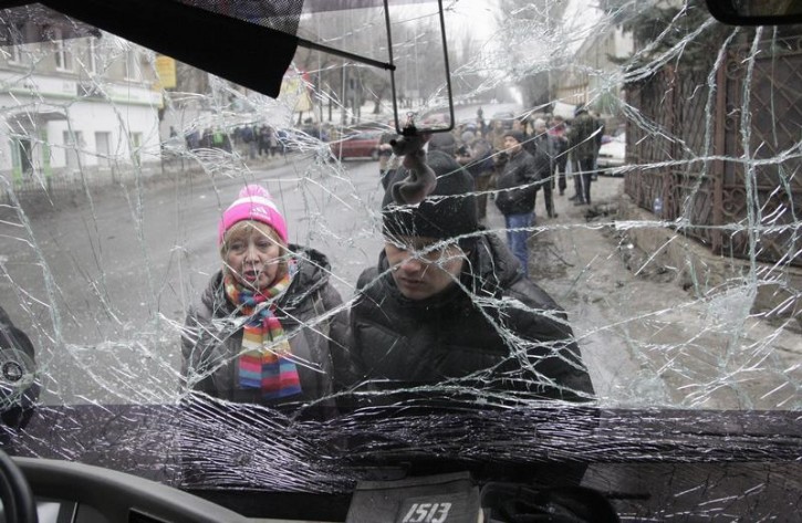 People look through the front windshield of a damaged trolleybus in Donetsk, January 22, 2015. Reuters