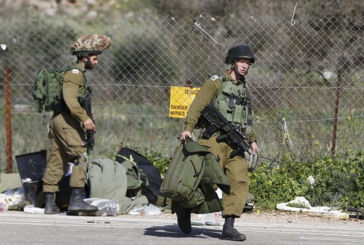 Israeli soldiers walk near Israel's border with Lebanon January 28, 2015. Reuters