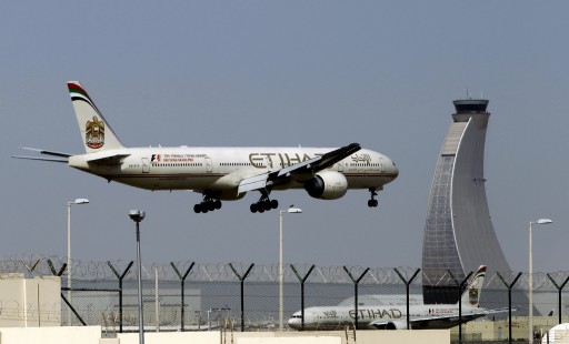 FILE - In this May 4, 2014 file photo, an Etihad Airways plane prepares to land at the Abu Dhabi airport in the United Arab Emirates. Hundreds of air travelers landed in San Francisco Saturday evening, Jan. 3, 2015, safe but irritated after a 28-hour Etihad overseas flight they say included 12 hours on a tarmac at the Abu Dhabi airport without food or accurate flight information. (AP Photo/Kamran Jebreili, File)