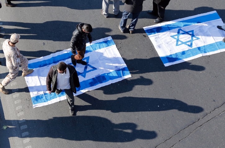  Iranians prepare to burn Israeli flags during the funeral ceremony of Iranian Revolutionary Guard commander General Mohammad Ali Allahdadi in Tehran, Iran, 21 January 2015. EPA