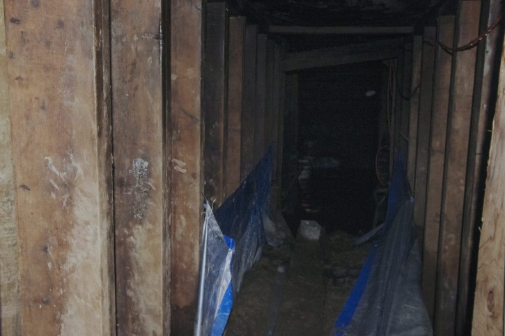 A copy of a Toronto Police photo of  a tunnel found near York University in Toronto is shown during a press conference about the  tunnel in Toronto on Tuesday, Feb. 24, 2015. Police are asking for the public's help in trying to determine who built the mysterious underground tunnel. (AP Photo/The Canadian Press, Chris Young)