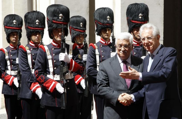File - Former Italian Prime Minister Mario Monti (R) shakes hands with Palestinian President Mahmoud Abbas (L) during a meeting at Chigi Palace in Rome July 17, 2012.  REUTERS/Alessandro Bianchi 