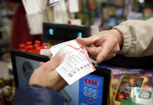 FILE - A customer buys tickets for the PowerBall lottery in New York, November 28, 2012. REUTERS