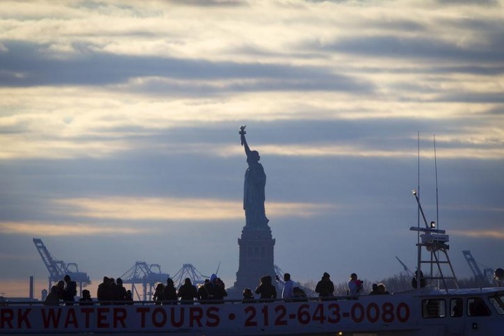 FILE - The Statue of Liberty is pictured behind a tourist boat in Battery Park in the Manhattan borough of New York, December 18, 2014. REUTERS/Carlo Allegri 