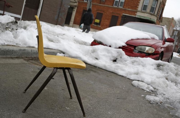 A chair marks a shovelled out parking spot in Chicago, Illinois, February 13, 2015. Lawn chairs, card tables and other items are placed on city streets by residents who sought to reserve their parking spaces - a controversial winter custom known as "dibs."  REUTERS/Jim Young  