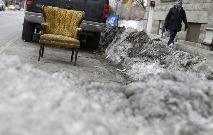 A chair marks a shovelled out parking spot in Chicago, Illinois, February 13, 2015. Lawn chairs, card tables and other items are placed on city streets by residents who sought to reserve their parking spaces - a controversial winter custom known as "dibs."  REUTERS/Jim Young