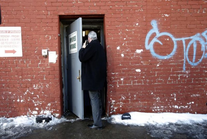 A law enforcement official enters 175-177 Dikeman Street which houses Dell's Maraschino Cherries company in the Brooklyn borough of New York City February 25, 2015. The Brooklyn maraschino cherry processor is under investigation after hidden marijuana plants were discovered in the family-owned business and its owner committed suicide while authorities were searching the premises during an unrelated raid, prosecutors said on Wednesday.   REUTERS/Mike Segar