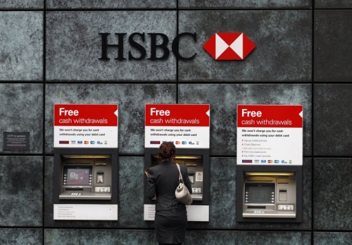 A woman uses a cash point machine at a HSBC bank. REUTERS/Andrew Winning