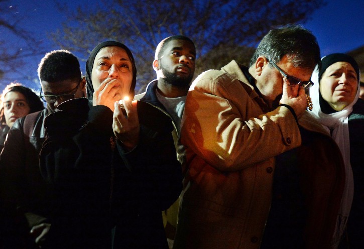 Namee Barakat, right, wipes away tears as he and his wife, Layla, left, watch photos projected on a screen during a vigil for his son, daughter-in-law and her sister, who were killed at a condominium near UNC-Chapel Hill, Wednesday, Feb. 11, 2015, in Chapel Hill, N.C. Craig Stephen Hicks appeared in court Wednesday on charges of first-degree murder in the deaths Tuesday of Deah Shaddy Barakat, his wife Yusor Mohammad and her sister Razan Mohammad Abu-Salha. (AP Photo/The News & Observer, Chuck Liddy)