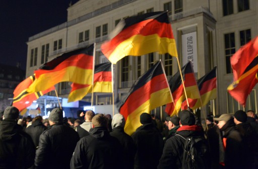 FILE - epa04574008 Participants of a 'Legida' demonstration, a local offshoot of the anti-Islam 'Pegida'  movement, wave German flags in front of the city's opera house, in Leipzig, Germany, 21 January 2015. EPA