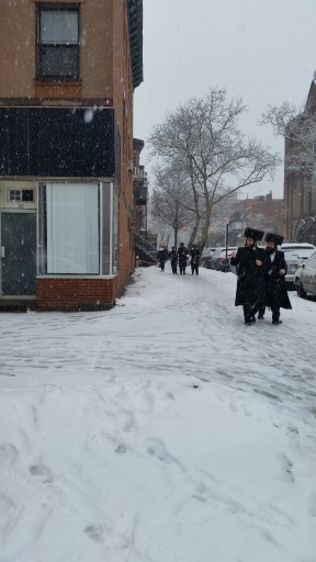 Men make their way through the snow covered streets on Purim in Willimasburg, Brooklyn, NY, 05 March 2015. 
