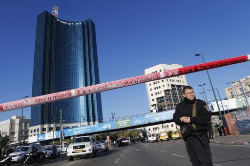 FILE - An Israeli police officer stands at a crime scene of in Tel Aviv January 21, 2015.REUTERS
