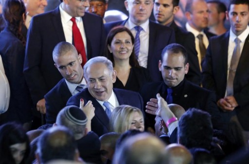Israeli Prime Minister Benjamin Netanyahu (C) greets supporters at party headquarters in Tel Aviv March 18, 2015.