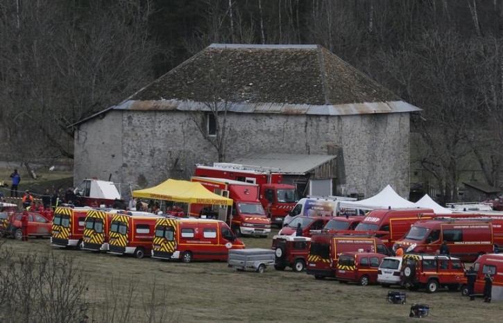 French fire brigade rescue units gather in a field near a farm buidling as they prepare to reach the crash site of an Airbus A320, near Seyne-les-Alpes, in the French Alps, March 24, 2015. REUTERS