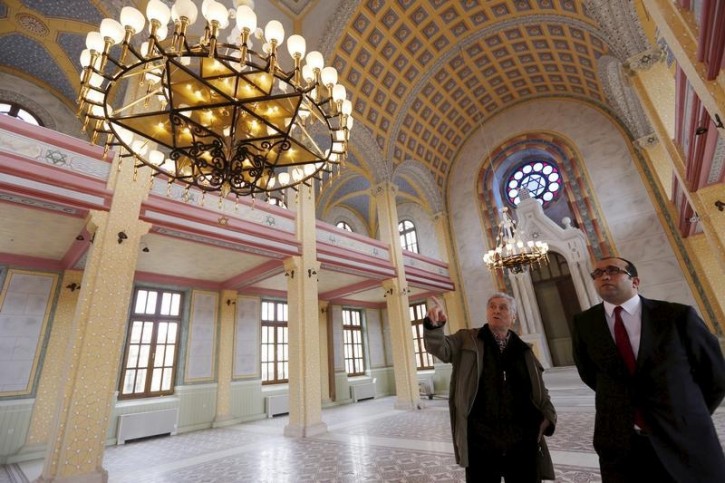 Rifat Mitrani (L), the town's last Jew, chats with Osman Guneren, local manager of the Directorate General of Foundations, as he visits the Great Synagogue during its restoration in Edirne, western Turkey, February 26, 2015.REUTERS