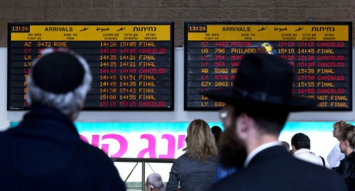 File: Israelis look at the arrivals board in Ben Gurion Airport outside Tel Aviv, Israel. EPA/JIM HOLLANDER