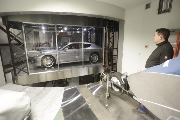 In this Tuesday, March 3, 2015 photo, a Porsche Panamera Turbo is used to test the car elevator and parking technology being developed for the Miami-area Porsche Design Tower at Mid-American Elevator Co., in Crest Hill, Ill. Each of the Porsche Design Tower's three car elevators will be able to whisk a vehicle, with its passengers still inside, up 60 stories and then slide it into the owners personal steel-reinforced garage. (AP Photo/M. Spencer Green)
