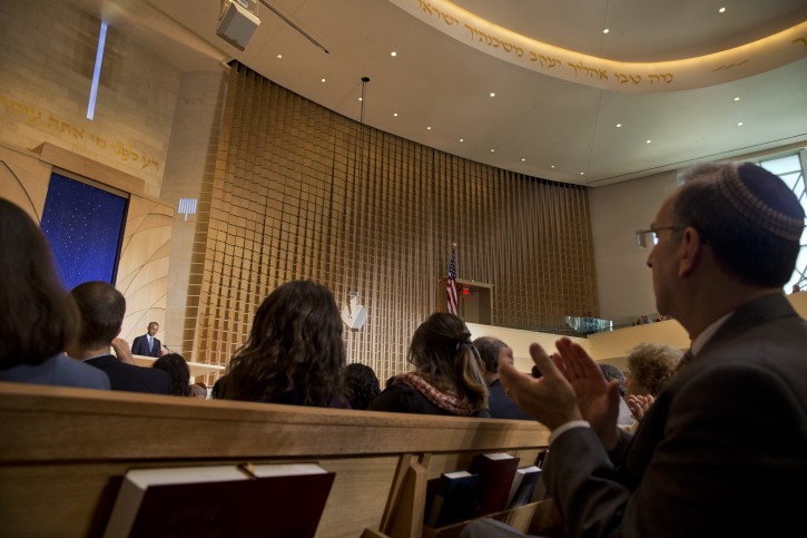 A man applauds as President Barack Obama speaks at Adas Israel Congregation in Washington, Friday May 22, 2015, as part of Jewish American Heritage Month. The president addressed one of the largest Jewish congregations in Washington to highlight efforts to combat anti-Semitism, a problem he says has created an intimidating environment worldwide for Jewish families. The appearance coincides with Solidarity Shabbat, devoted to showing unity by political leaders in Europe and North America against anti-Semitism. (AP Photo/Jacquelyn Martin)