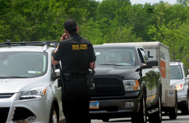 New York State Police talk with motorists at a check point in Cadyville Sunday June 7, 2015. Two inmates, David Sweat and Richard Matt, escaped Saturday morning from Clinton Correctional Facility and are still at large.   (AP-Press-Republican, Rob Fountain)