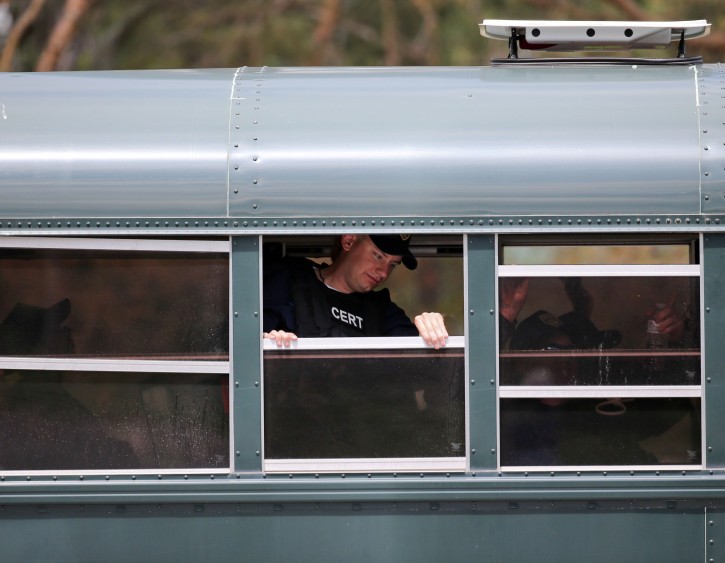 Corrections officers are transported by bus to a search area as the search for two escaped prisoners from Clinton Correctional Facility in Dannemora continues, on Monday, June 22, 2015, in Mountain View, N.Y.(AP Photo/Mike Groll)