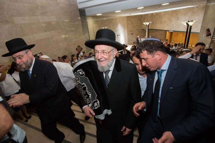 Rabbi Yisrael Meir Lau (C), Chief Rabbi of Tel Aviv carries a torah scroll as he celebrates a new torah scroll brought to the synagogue of the Knesset, Israeli parliament in Jerusalem on June 9, 2015. Photo by Yonatan Sindel/Flash90 