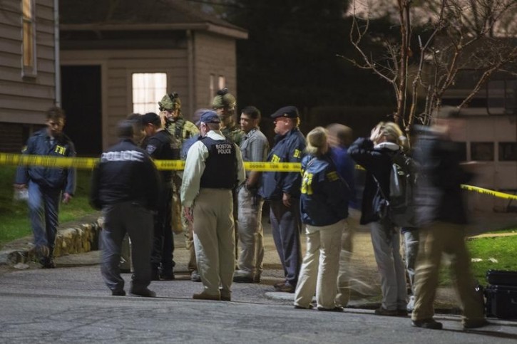 FILE - FBI and Boston Police officers stand in front of the house at 67 Franklin St. where Dzhokhar Tsarnaev, the surviving suspect in the Boston Marathon bombings, was hiding near in Watertown, Massachusetts, April 19, 2013.REUTERS