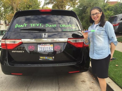 Margot Grabie next to her car marked with 'Don't text, Just Drive' message on July 21, 2015