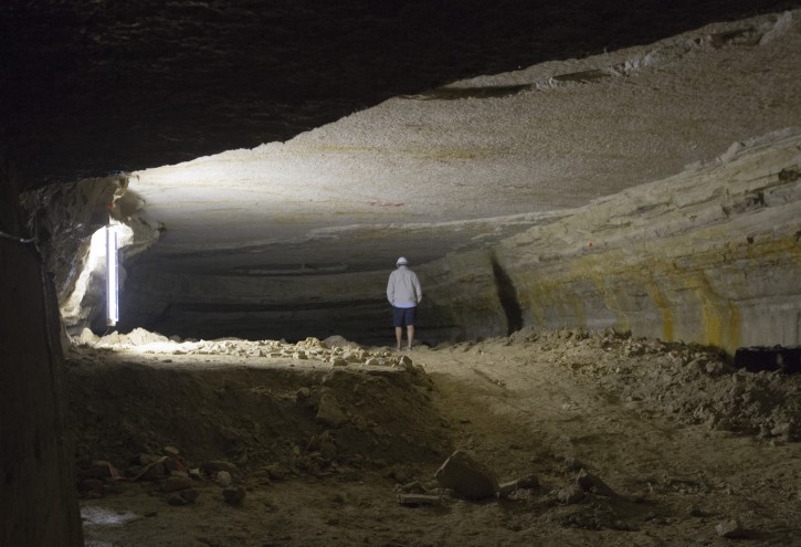 Visitors tour the depths of the Vincennes quarry during a press visit, near Paris, France, Wednesday Aug.  5, 2015. (AP Photo/Jacques Brinon)
