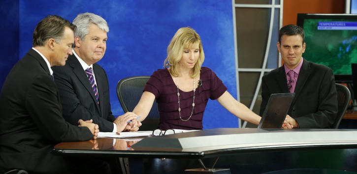WDBJ-TV7 news morning anchor Kimberly McBroom, second from right, and meteorologist Leo Hirsbrunner, right, are joined by visiting anchor Steve Grant, second from left, and Dr. Thomas Milam, of the Carilion Clinic, as they observe a moment of silence during the early morning newscast at the station, in Roanoke, Va., Thursday, Aug. 27, 2015. (AP Photo/Steve Helber)