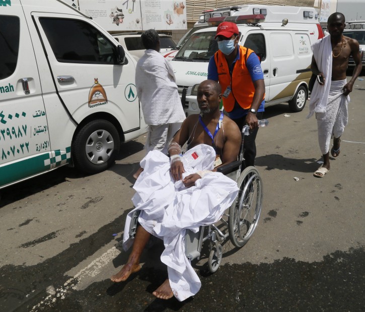 A rescue worker attends to a man injured in Mina, Saudi Arabia during the annual hajj pilgrimage on Thursday, Sept. 24, 2015. Hundreds were killed and injured, Saudi authorities said. The crush happened in Mina, a large valley about five kilometers (three miles) from the holy city of Mecca that has been the site of hajj stampedes in years past. (AP Photo)