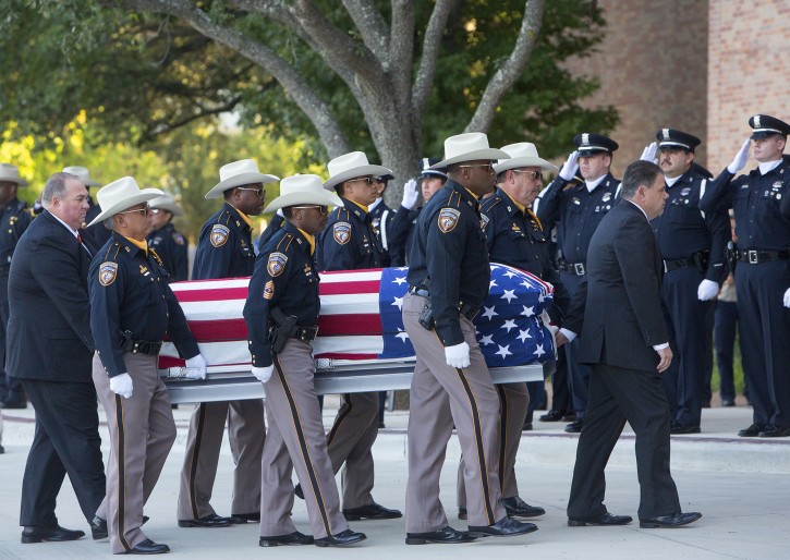 The Harris County Sheriff's Department carries in the casket of Deputy Darren Goforth towards Second Baptist Church for his funeral service, Friday, Sept. 4, 2015, in Houston. Goforth was killed a week ago while filling his patrol car with gasoline at a suburban Houston convenience store. A 30-year-old Houston man is charged with his slaying. (Cody Duty/Houston Chronicle via AP) 