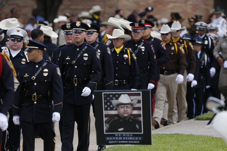 Law enforcement officials file out after the funeral service for Harris County Sheriff's Deputy Darren Goforth at Second Baptist Church, Friday, Sept. 4, 2015, in Houston. Goforth was killed a week ago while filling his patrol car with gasoline at a suburban Houston convenience store. A 30-year-old Houston man is charged with his slaying. (Steve Gonzales/Houston Chronicle via AP)