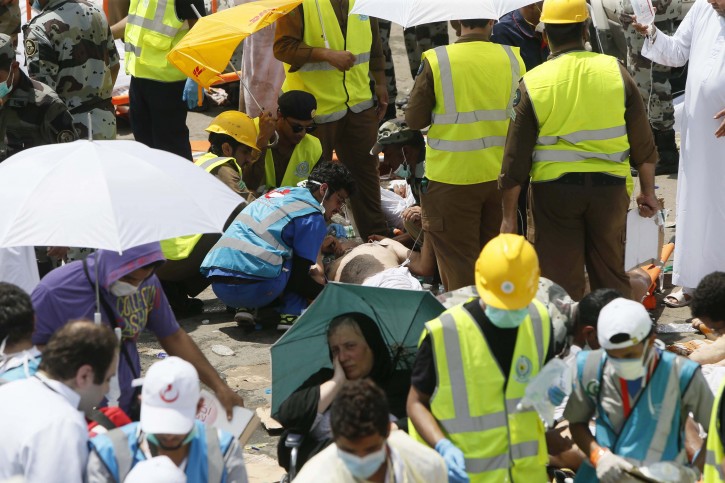 Rescue workers attend to victims of a stampede in Mina, Saudi Arabia during the annual hajj pilgrimage on Thursday, Sept. 24, 2015. Hundreds were killed and injured, Saudi authorities said. The crush happened in Mina, a large valley about five kilometers (three miles) from the holy city of Mecca that has been the site of hajj stampedes in years past. (AP Photo)