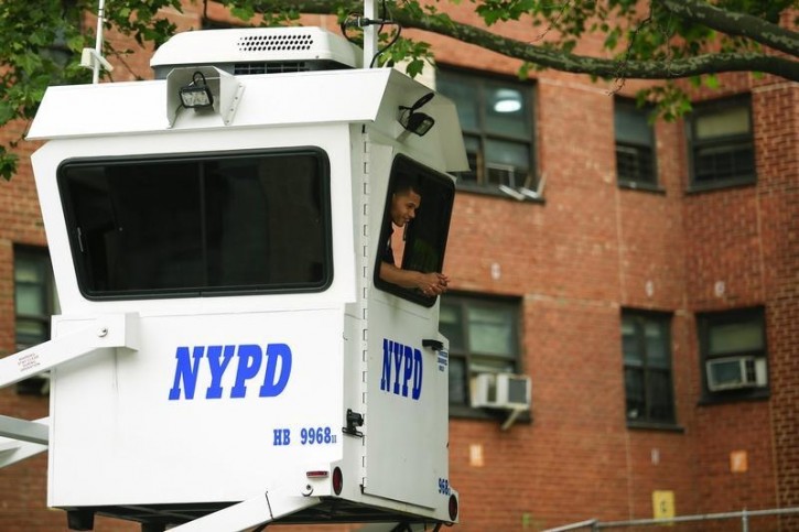 FILE - A NYPD officer looks form his booth as he checks the security in New York June 04, 2014. Reuters