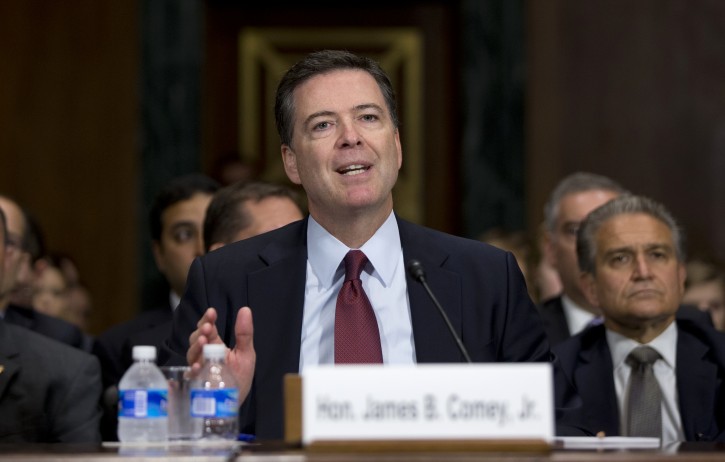 FILE - In this July 8, 2015 file photo, FBI Director James Comey testifies on Capitol Hill in Washington. Comey is confirming that the FBI is looking into the security of the setup of Hillary Rodham Clinton's email. But he's not answering questions about the investigation.   (AP Photo/Carolyn Kaster, File)